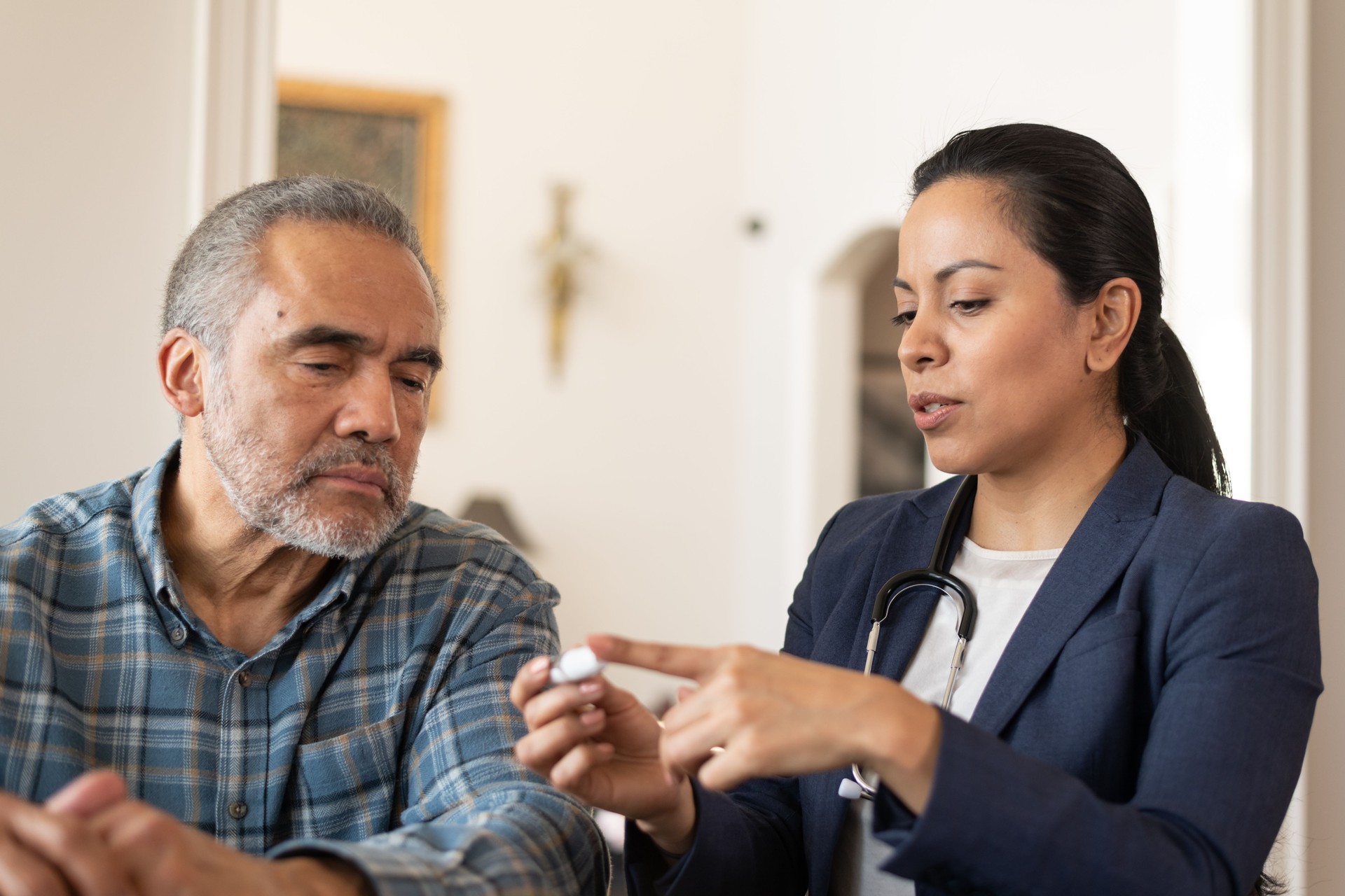 Latin Female Doctor Helping Patient at Home With Diabetes