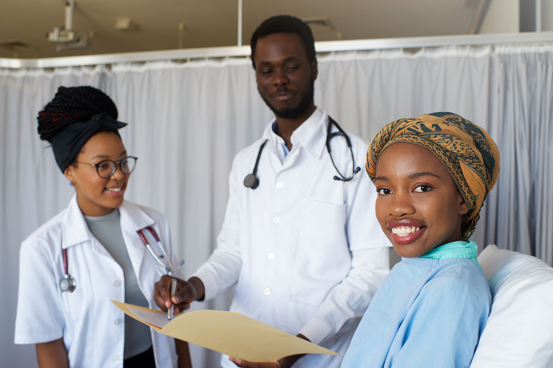 Happy Female Patient Portrait in hospital with two doctors